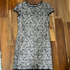 Designer cocktail dress in soft pink and black with artistic lace